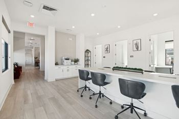 A white office with a long counter and chairs